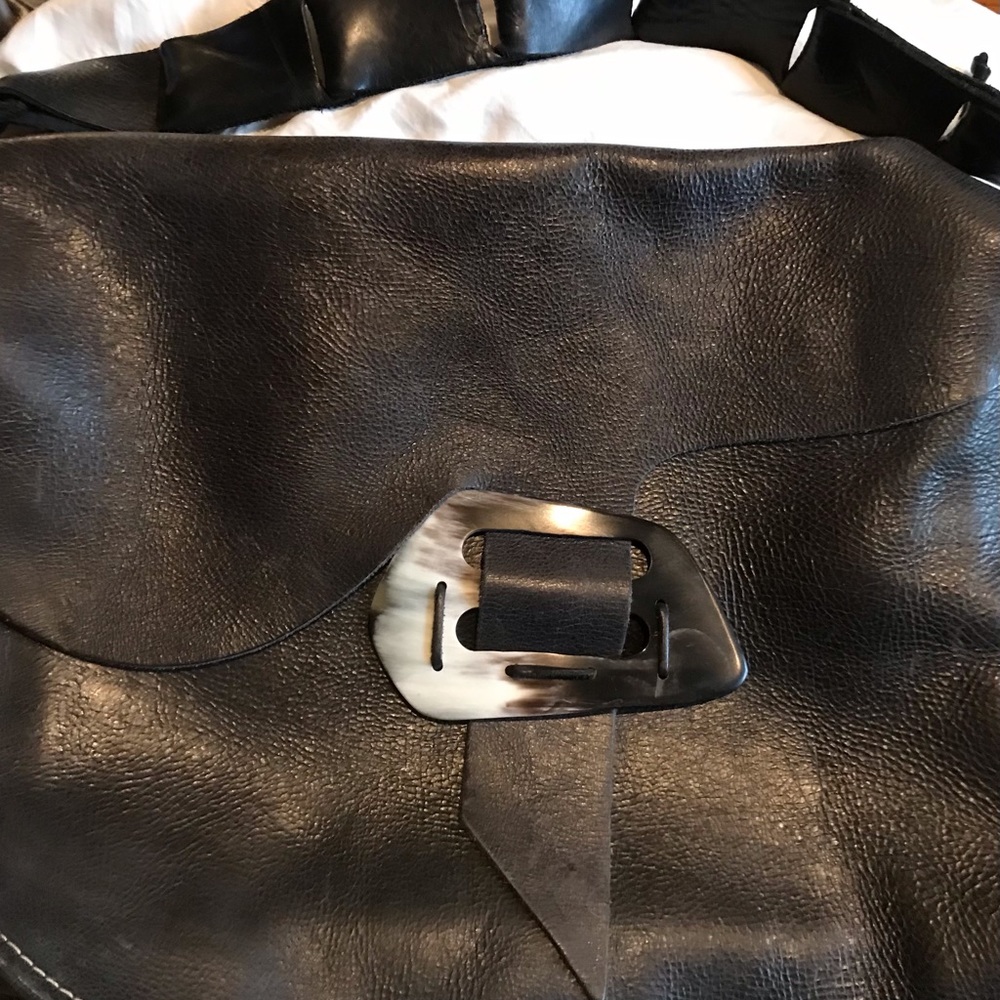 Black leather Sulay Rodriguez messenger bag.